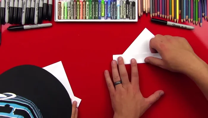 Fold the bottom edges up, aligning them with the center crease.