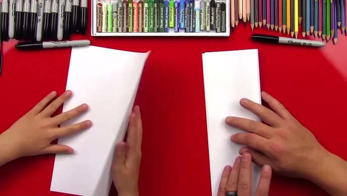 Open the paper and fold it in half the opposite way, ensuring crisp creases.