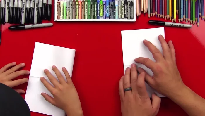 Open the paper and fold it in half the opposite way, ensuring crisp creases.