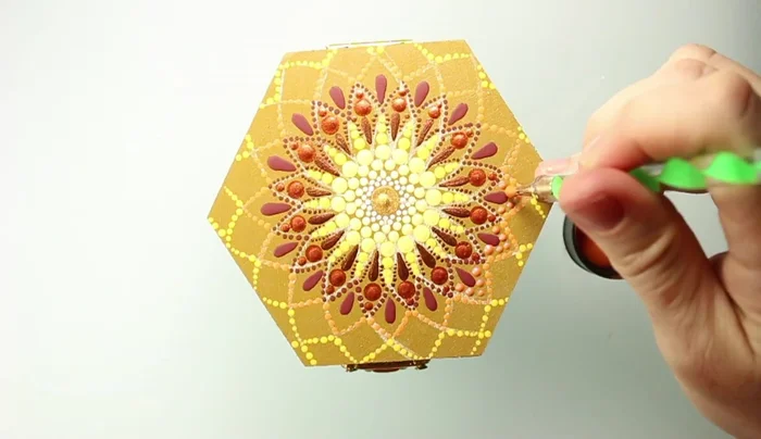 Add orange dots using a dotting rod that fits in the space between existing shapes.