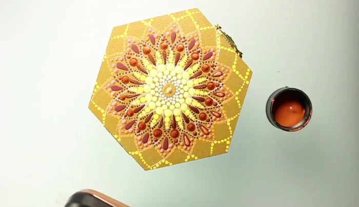 Add orange dots using a dotting rod that fits in the space between existing shapes.