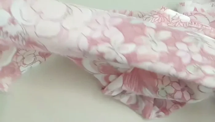 Make a hole at each end of fabric strips by layering, folding, and cutting a slit.