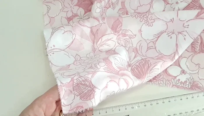 Make a hole at each end of fabric strips by layering, folding, and cutting a slit.