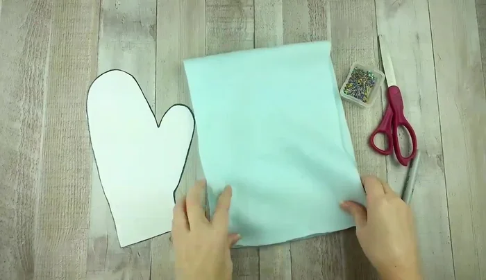 Cut out both layers of fabric along the traced line, ensuring they remain together.