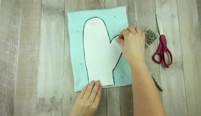 Cut out both layers of fabric along the traced line, ensuring they remain together.