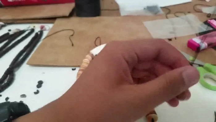 Tie a double knot on top of the clasp to secure it.