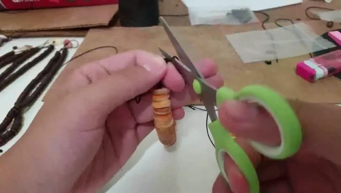 Trim the excess rope, leaving a small amount. Burn the ends of the rope to prevent fraying.