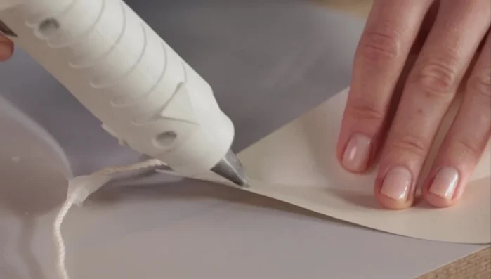 Attach the stems of the leaves to a piece of string, alternating Vellum and card stock leaves.