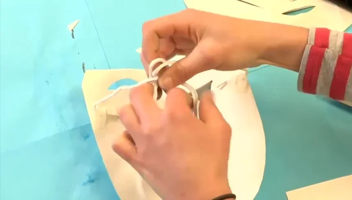 Tie the strings at the back to adjust the fit around your face. The mask is ready to wear!