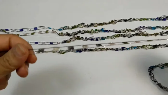 Fasten off, leaving a 10-inch tail. Repeat this process four more times to create five 18-inch chains.