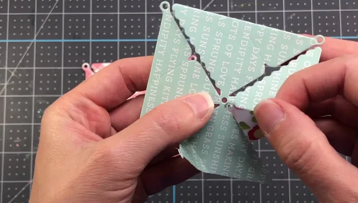 Push the brad through the center hole and secure it.