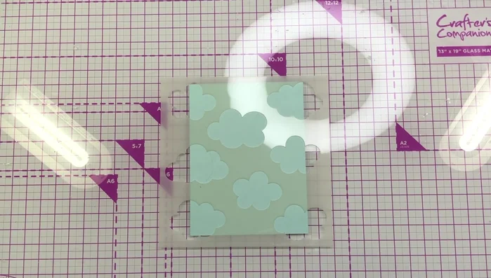 Die cut a scalloped border from green cardstock and add ink for dimension.