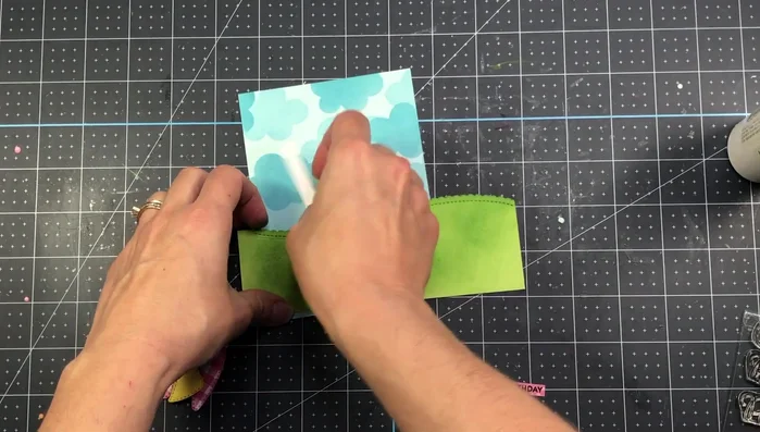 Add the sentiment and pearl. Attach the card layer to the patterned paper and then to the A2 card base.