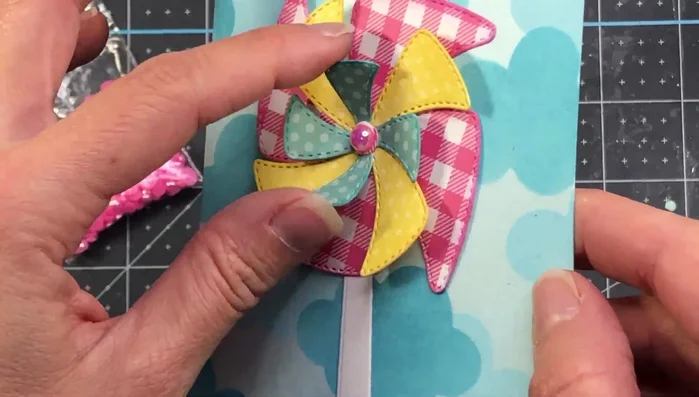 Add the sentiment and pearl. Attach the card layer to the patterned paper and then to the A2 card base.