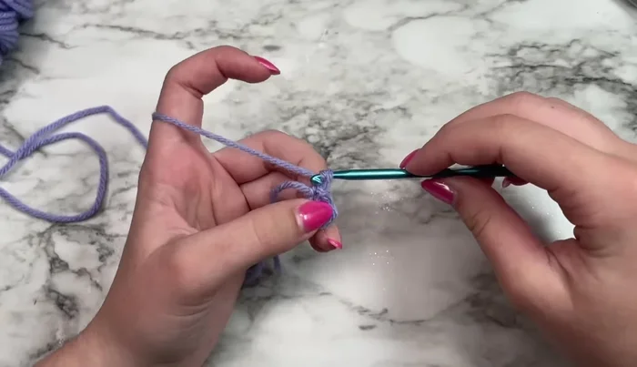 Work three double crochets in the ring.