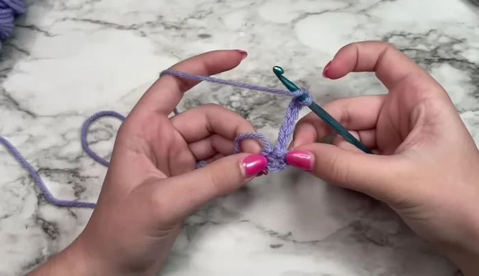 Work three double crochets in the ring.