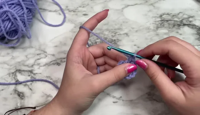 Work three double crochets in the ring.