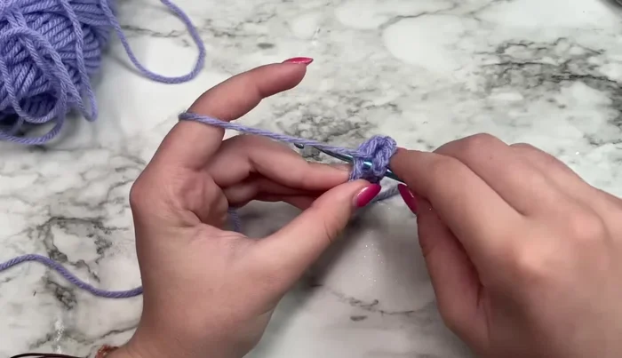 Work three double crochets in the ring.