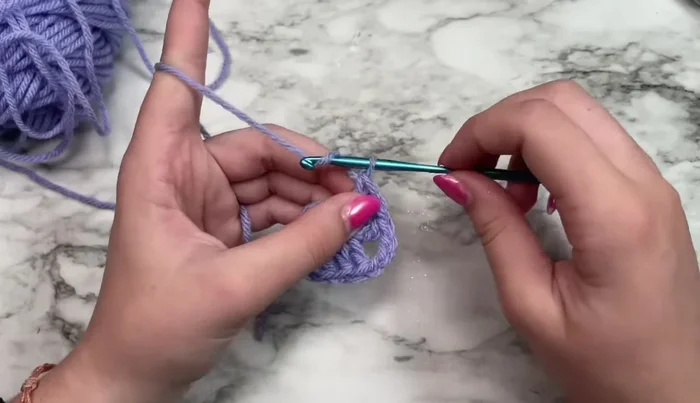 Slip stitch into the third chain of the initial chain-six to join the round.