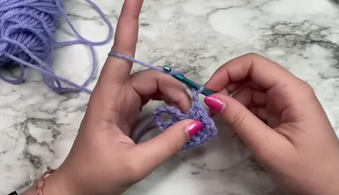 Slip stitch into the third chain of the initial chain-six to join the round.