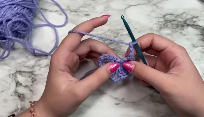 Slip stitch into the third chain of the initial chain-six to join the round.