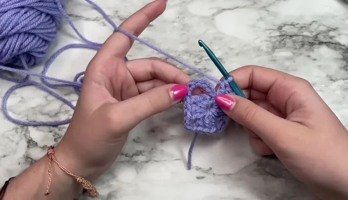 Slip stitch into the third chain of the initial chain-six to join the round.