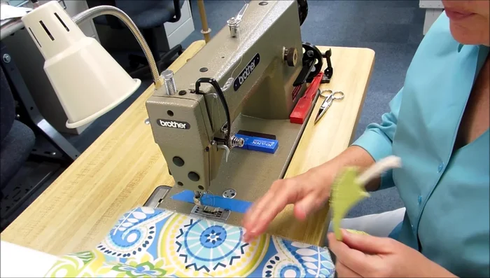 Apply cording to fabric: Using a zipper foot, sew the cording onto one side of the pillow fabric, starting at the bottom edge. Ease in the cording slightly to avoid puckering. Clip the cording at corners to help it turn smoothly.