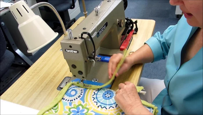 Join cording ends: When you reach the starting point, stop a few inches away. Open the ends of the cording, cut them at an angle to create a seamless join, and sew together.