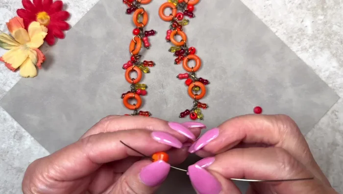 Create Pendant Dangle: Slide a bead onto 22 gauge wire, bend the wire to create a loop at the top of the bead, and wrap the excess wire to secure it.