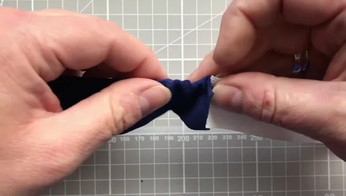 Secure elastic ends: Once elastic is fully threaded, use a safety pin to prevent it from pulling through, approximately 2 cm from each end.