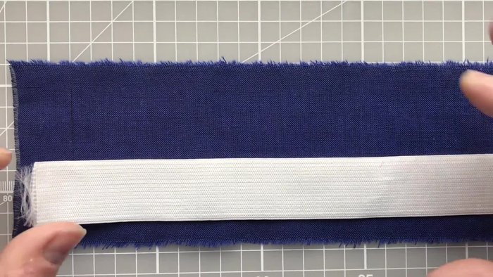 Measure and cut elastic (25cm) and fabric (8cm x 50cm).