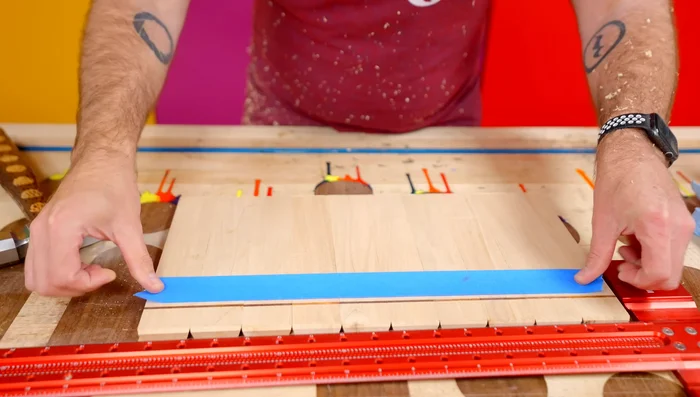 Drill a drainage hole in the plywood base. Add glue to the base and insert into the holder.