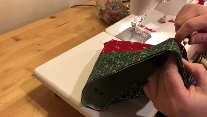 Prepare and insert drawstrings: Heat-seal the ends of two 32" ribbons to prevent fraying. Using a safety pin, thread the ribbons through the drawstring channels.