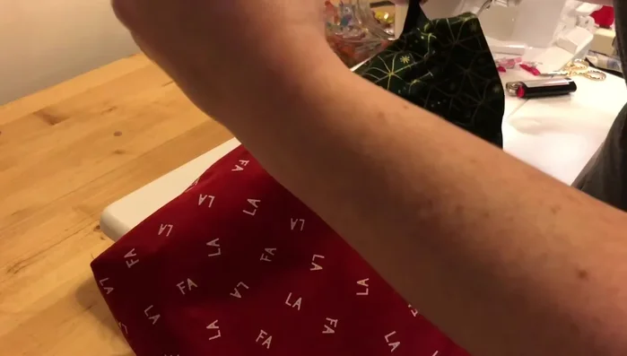 Tie drawstrings: Once both ribbons are threaded, tie a knot at each end to secure the drawstrings.